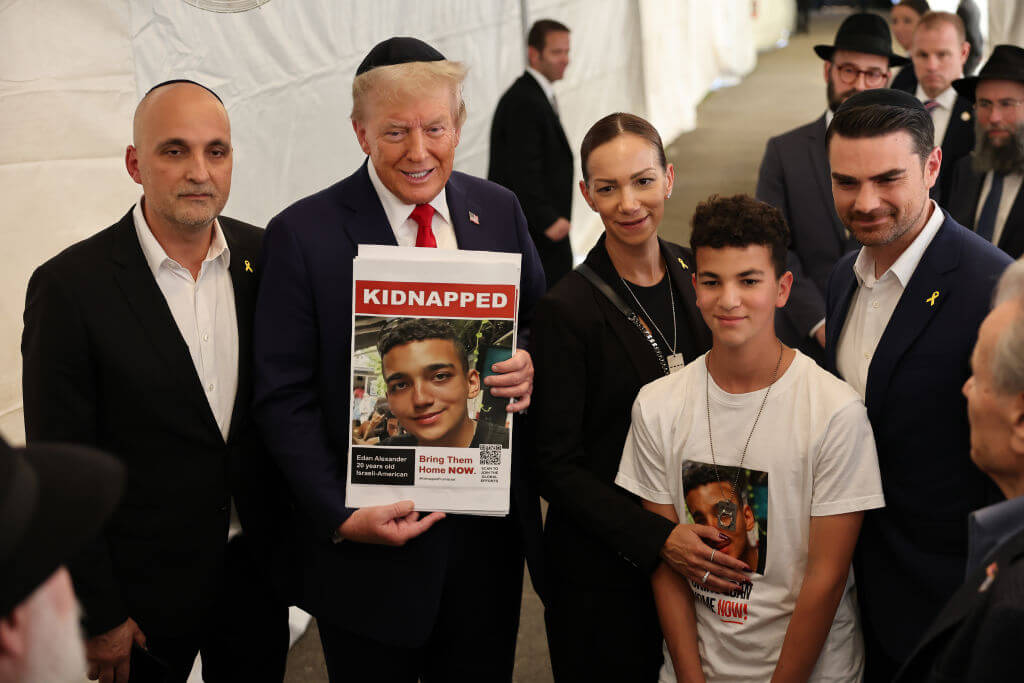 President-elect Donald Trump with the family of Edan Alexander and, at right, conservative commentator Ben Shapiro, on Oct. 07, 2024 at the grave of the Lubavitcher Rebbe.