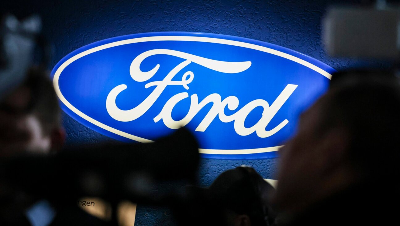 An illuminated Ford company sign shines on the sidelines of a works meeting at the company’s Germany site in Cologne, Dec. 10, 2024. (Christoph Reichwein/picture alliance via Getty Images)