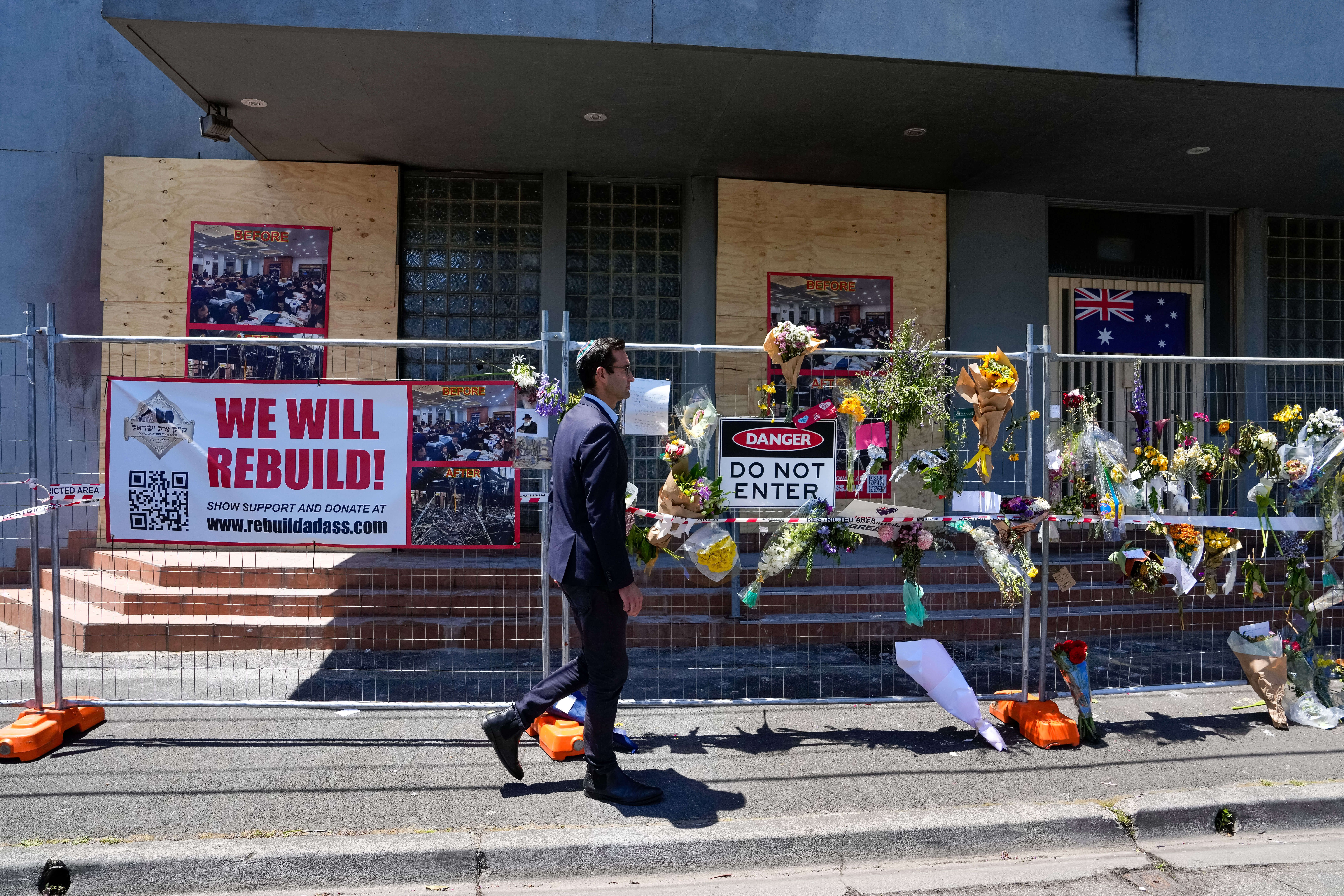 Member of Parliament Josh Burns walks past the damaged Adass Israel Synagogue on Dec. 10, 2024 in Melbourne, Australia after an arson attack.