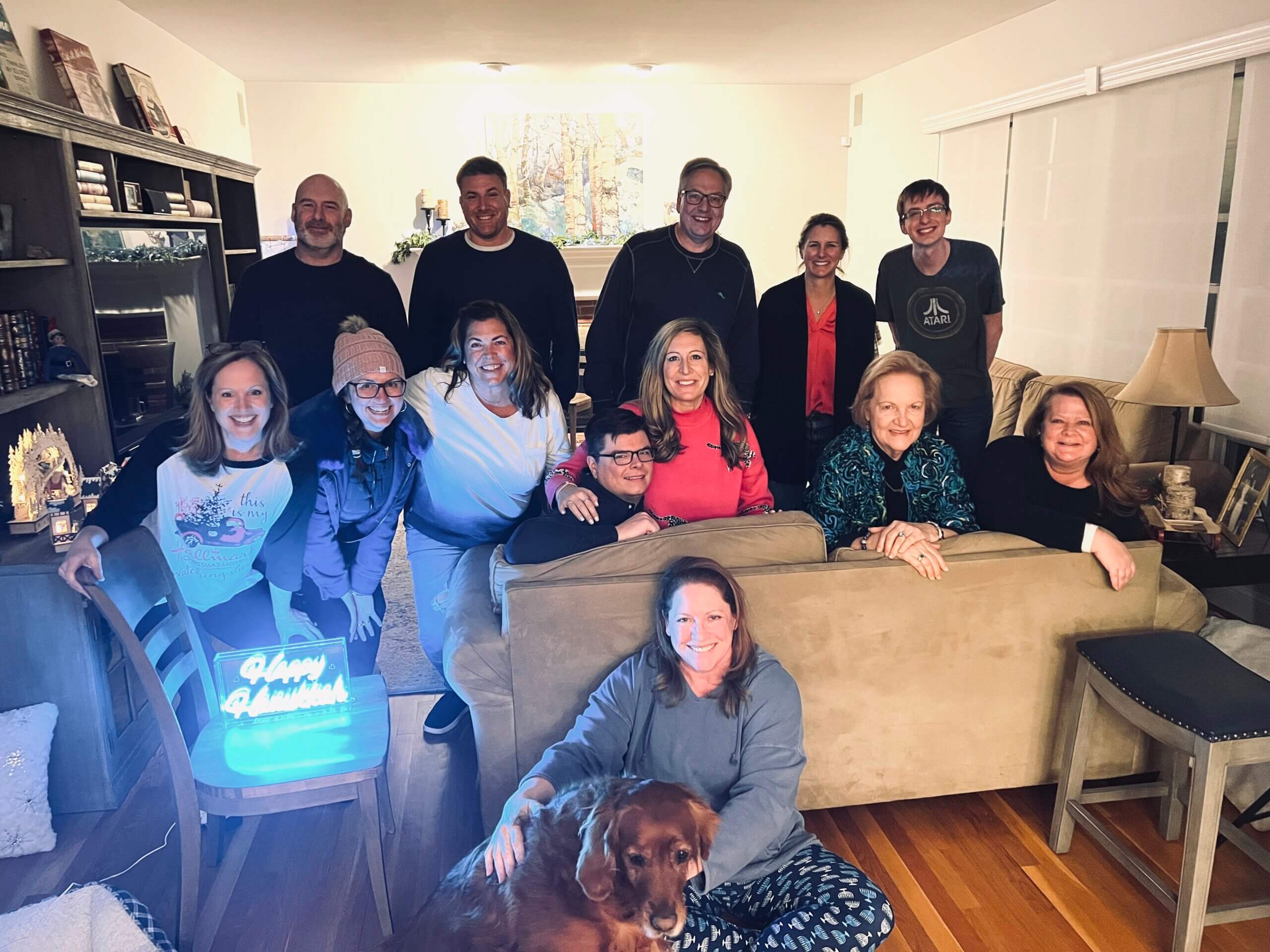 Julie Sherman Wolfe, sitting, at a watch party for 'Hanukkah on Rye' in 2022.