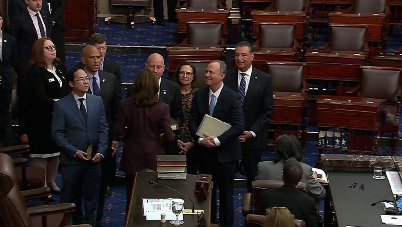 Senator Adam Schiff is sworn in to the U.S. Senate holding a Maimonides Mishneh Torah.