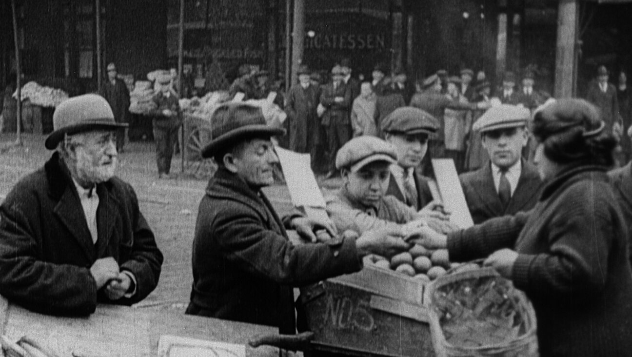 Still from “Breaking Home Ties” (1922). Mr. Bergmann, the protagonist’s father (far left) struggles as an immigrant street vendor after leaving Russia for New York City. (Courtesy National Center for Jewish Film)