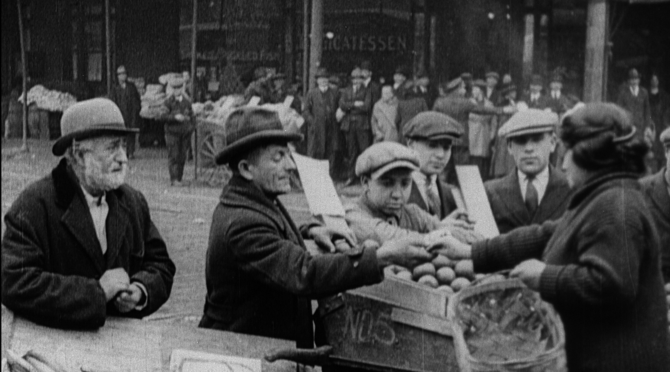 Still from “Breaking Home Ties” (1922). Mr. Bergmann, the protagonist’s father (far left) struggles as an immigrant street vendor after leaving Russia for New York City. (Courtesy National Center for Jewish Film)