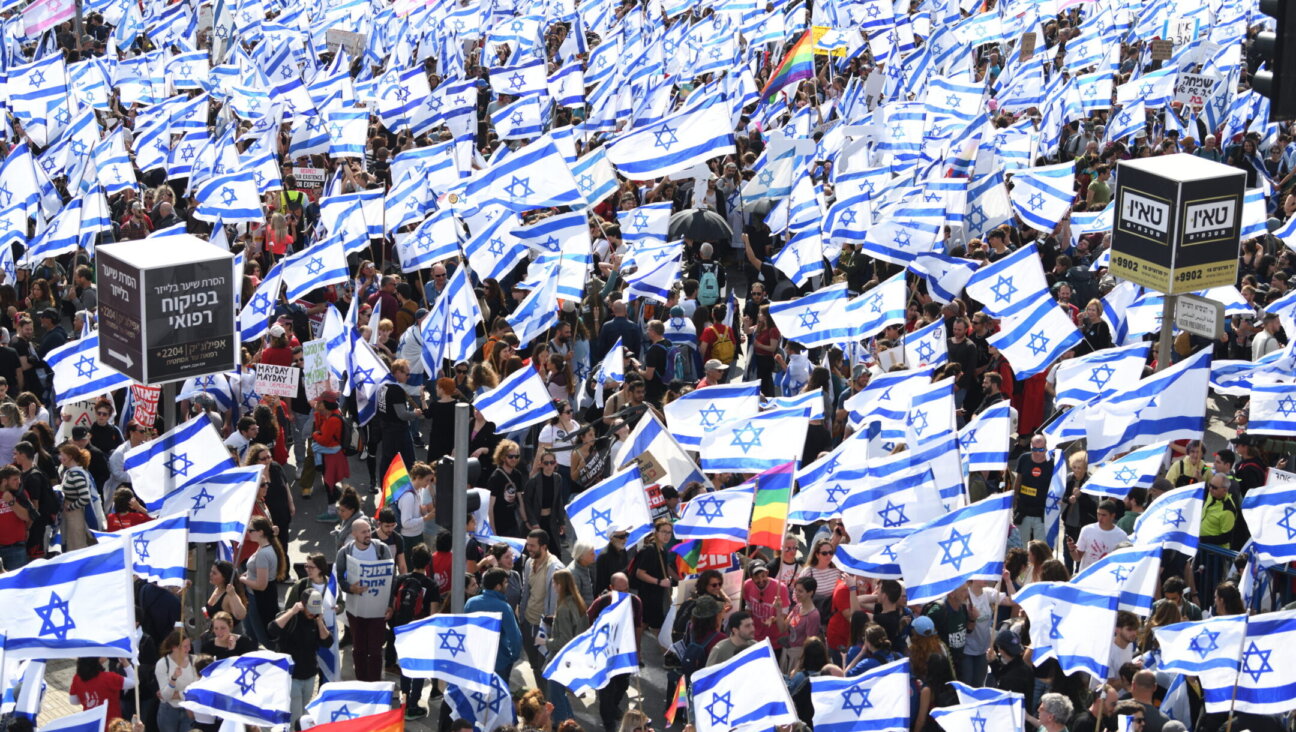 Thousands of Israeli protesters wave flags during a rally against the Israeli government’s judicial overhaul bills in Jerusalem, March 27, 2023. (Gili Yaari/Flash90)