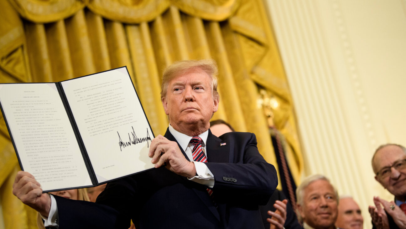 President Donald Trump shows an executive order regarding antisemitism during a Hanukkah reception at the White House on December 11, 2019. He is expected to sign a new order addressing antisemitism Wednesday.