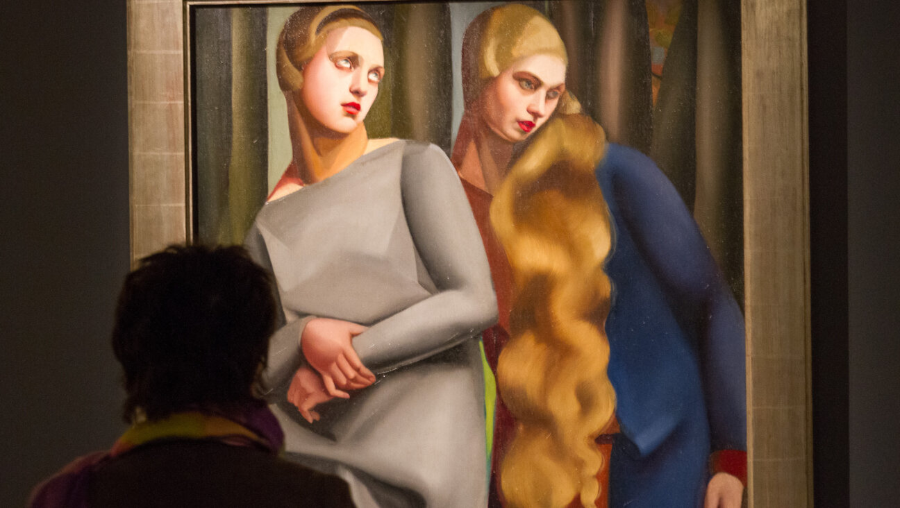 A visitor studies an exhibit on display at the Exhibition - 'Tamara de Lempicka, Queen of the Art Deco' exhibition opening at La Pinacotheque on April 17, 2013 in Paris, France.  