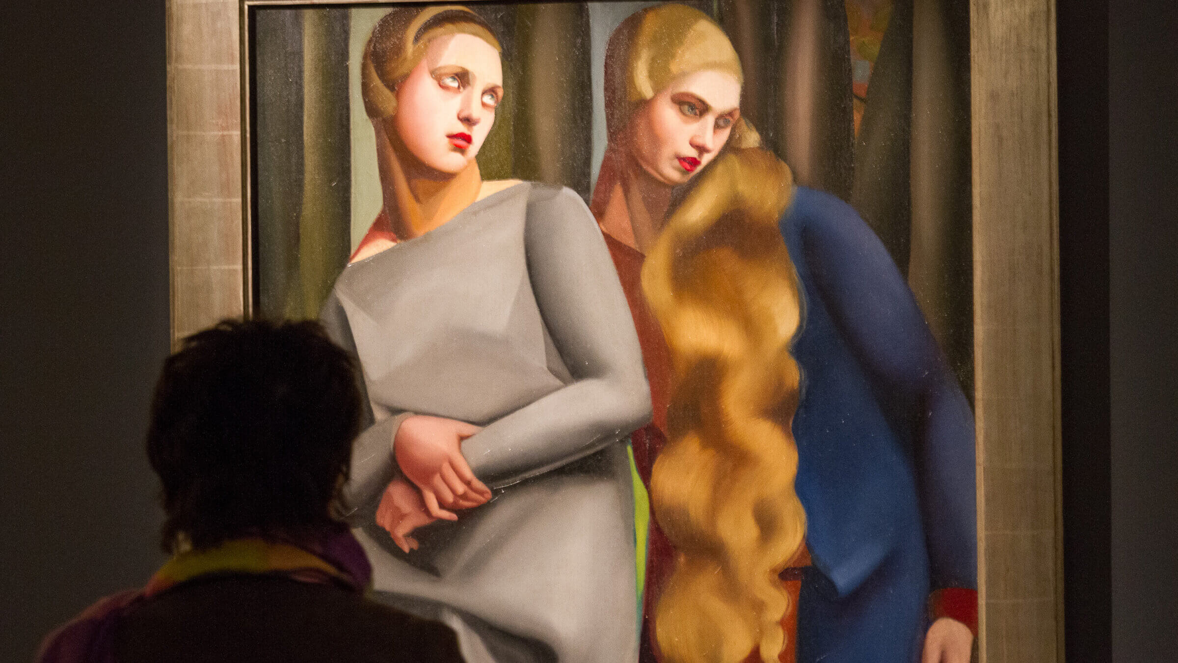 A visitor studies an exhibit on display at the Exhibition - 'Tamara de Lempicka, Queen of the Art Deco' exhibition opening at La Pinacotheque on April 17, 2013 in Paris, France.  