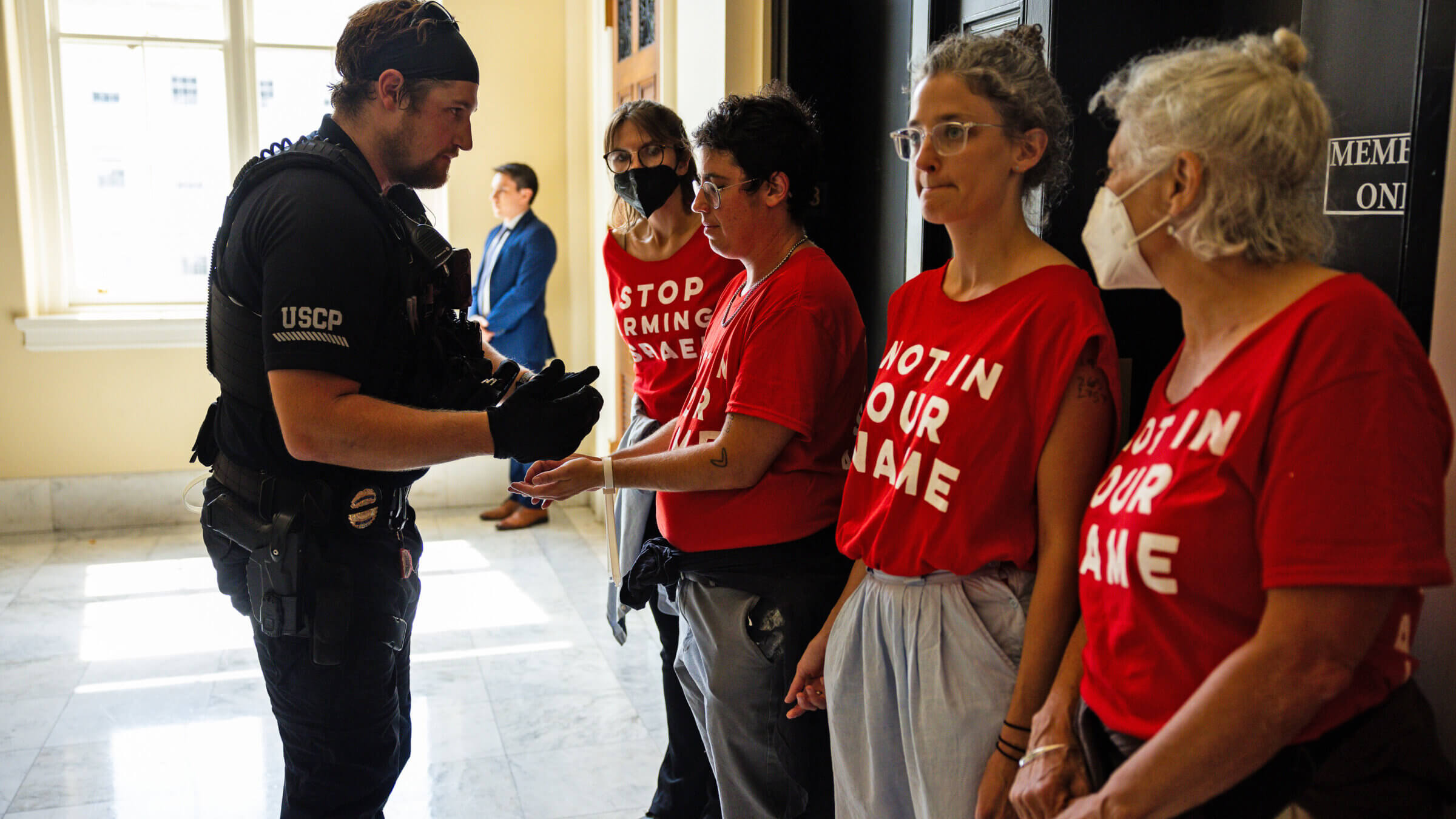 Demonstrators from Jewish Voice For Peace are taken into custody as they protest the war in Gaza at the Canon House Building in July. The organization recently settled fraud allegations related to their eligibility for pandemic-era relief.