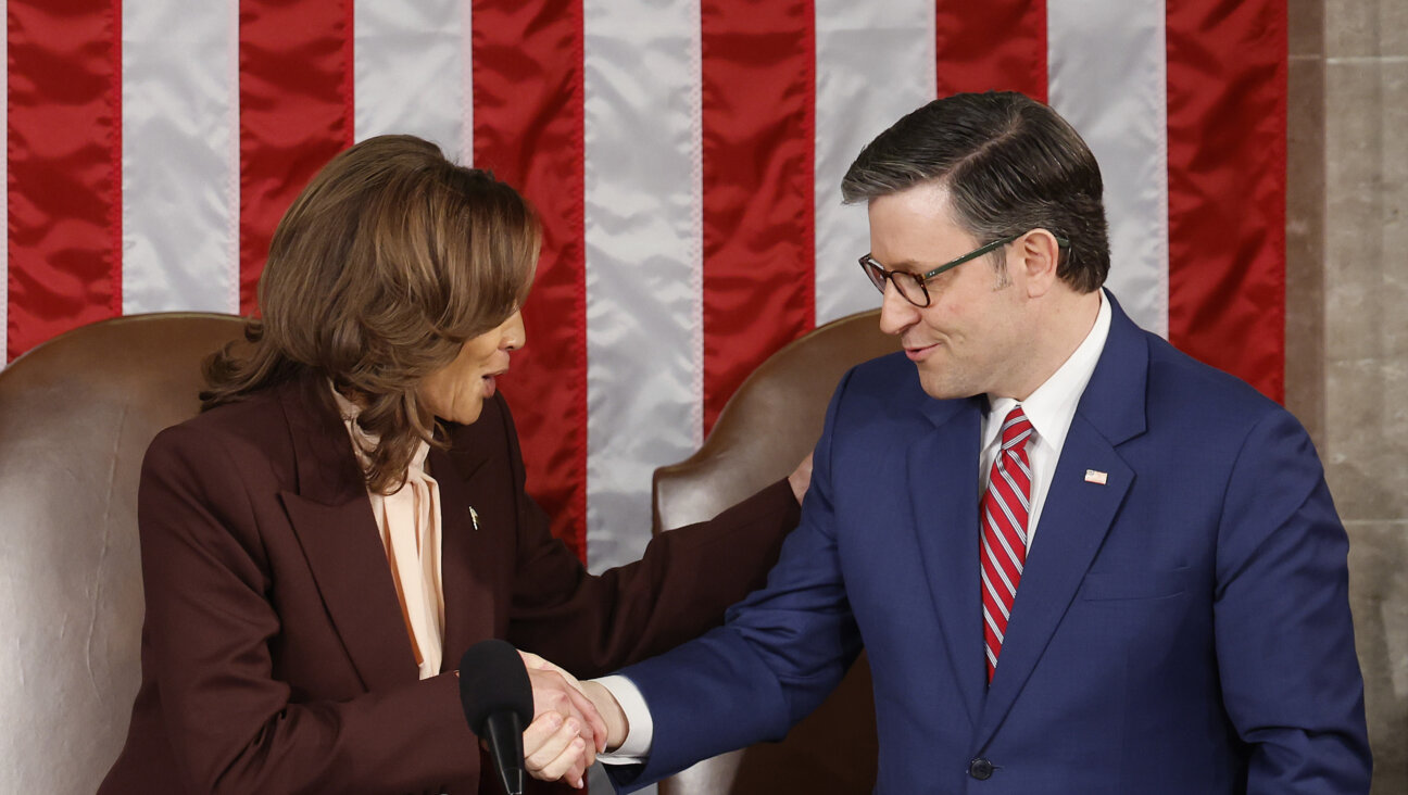 U.S. Vice President Kamala Harris  shakes hands with U.S. Speaker of the House Mike Johnson after Harris certifies the Electoral College vote.