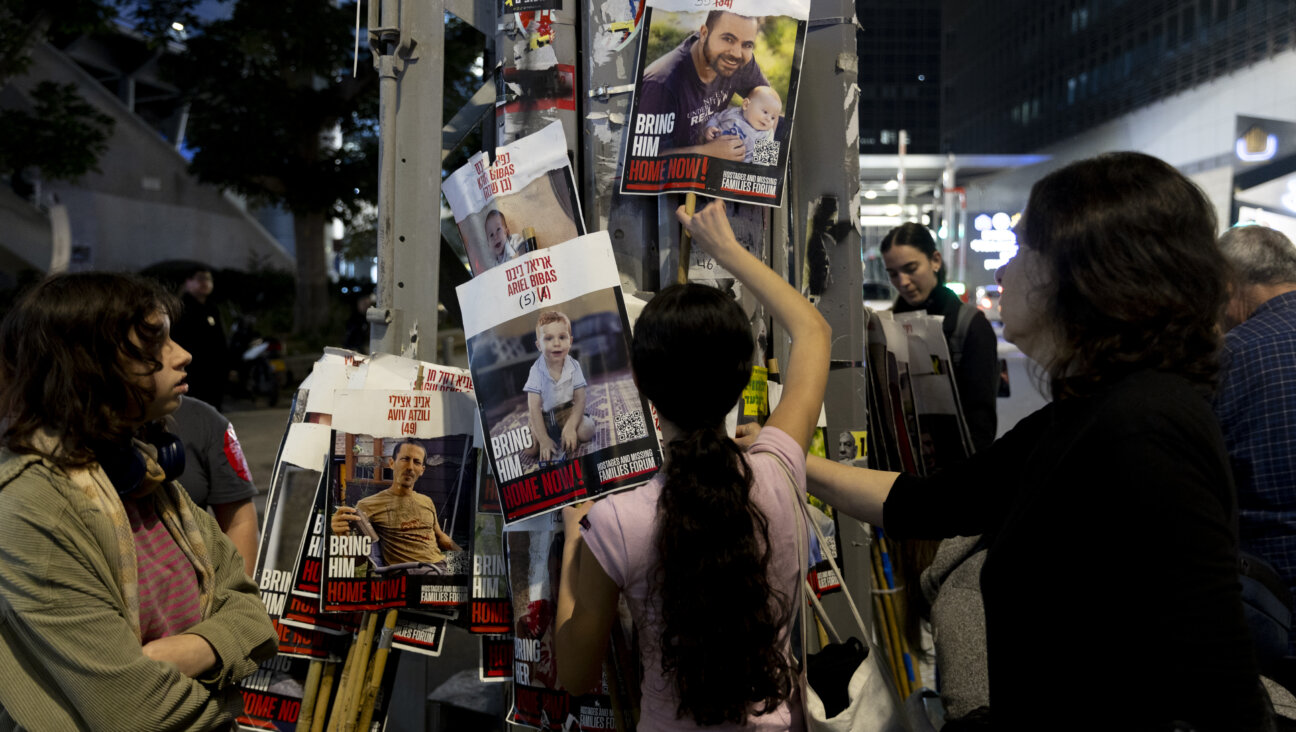 People gather to take photos of hostages held in the Gaza Strip.