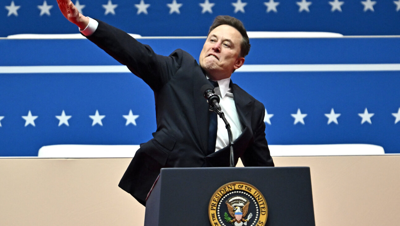 Elon Musk gestures as he speaks during the inaugural parade inside Capitol One Arena