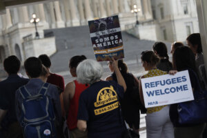 Activists hold signs during a demonstration organized by HIAS outside the U.S. Capitol in 2017. The organization has been forced to make deep cuts to its budget even as it seeks to prepare for a second Trump administration.