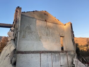 The mural was concealed by sheetrock, and later bookshelves, in a building being used as preschool offices.