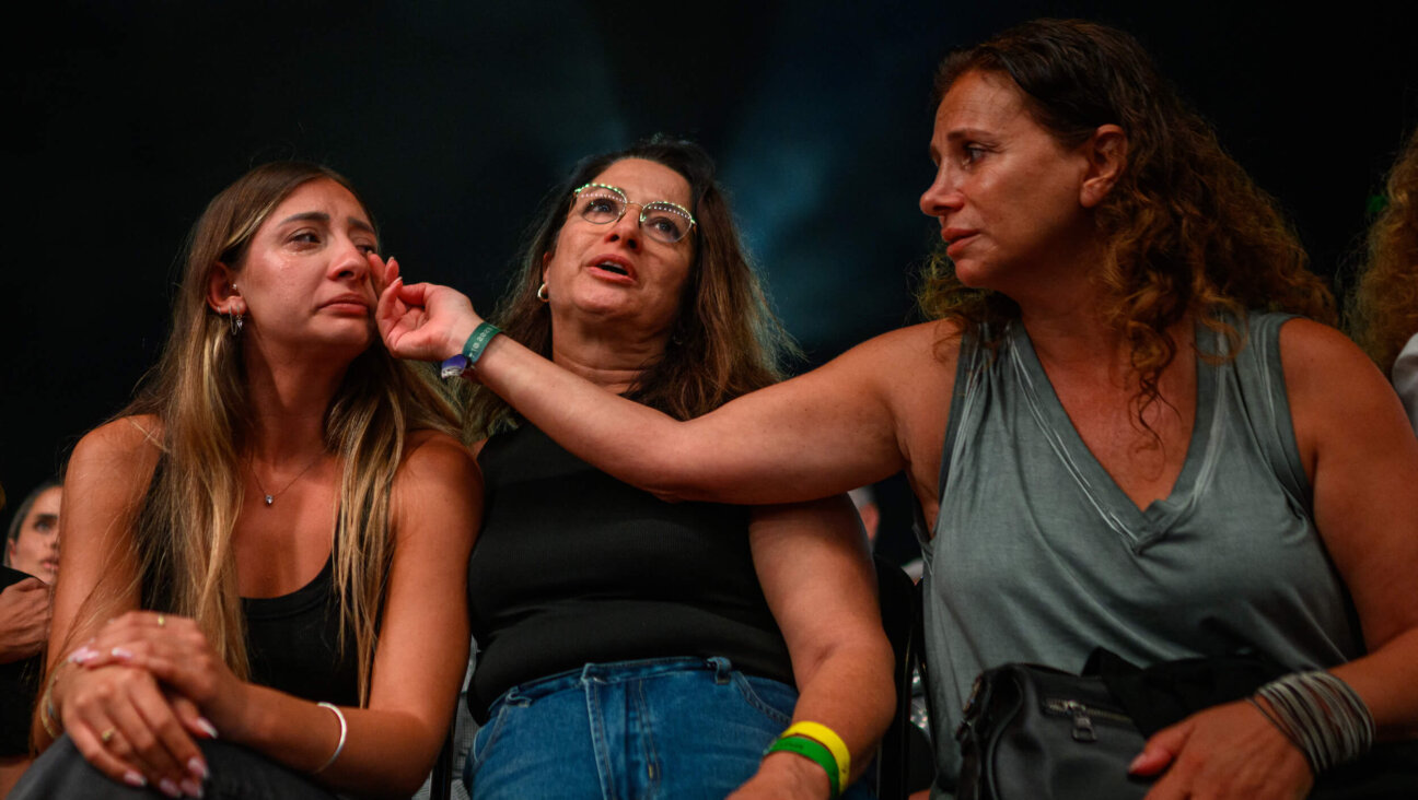 Relatives and friends of people killed on Oct. 7 cry during a ceremony commemorating the first anniversary of the attack.