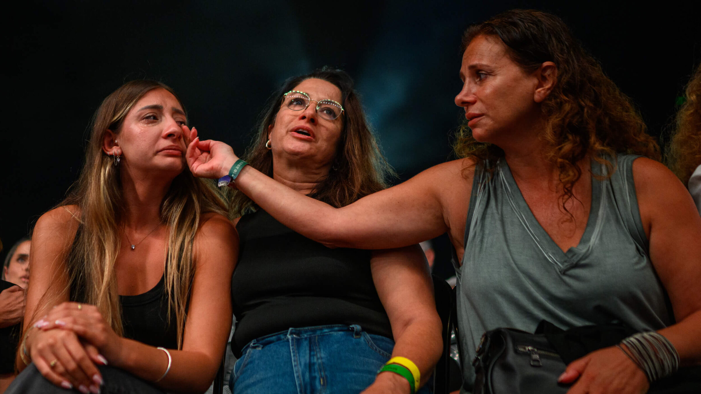 Relatives and friends of people killed on Oct. 7 cry during a ceremony commemorating the first anniversary of the attack.