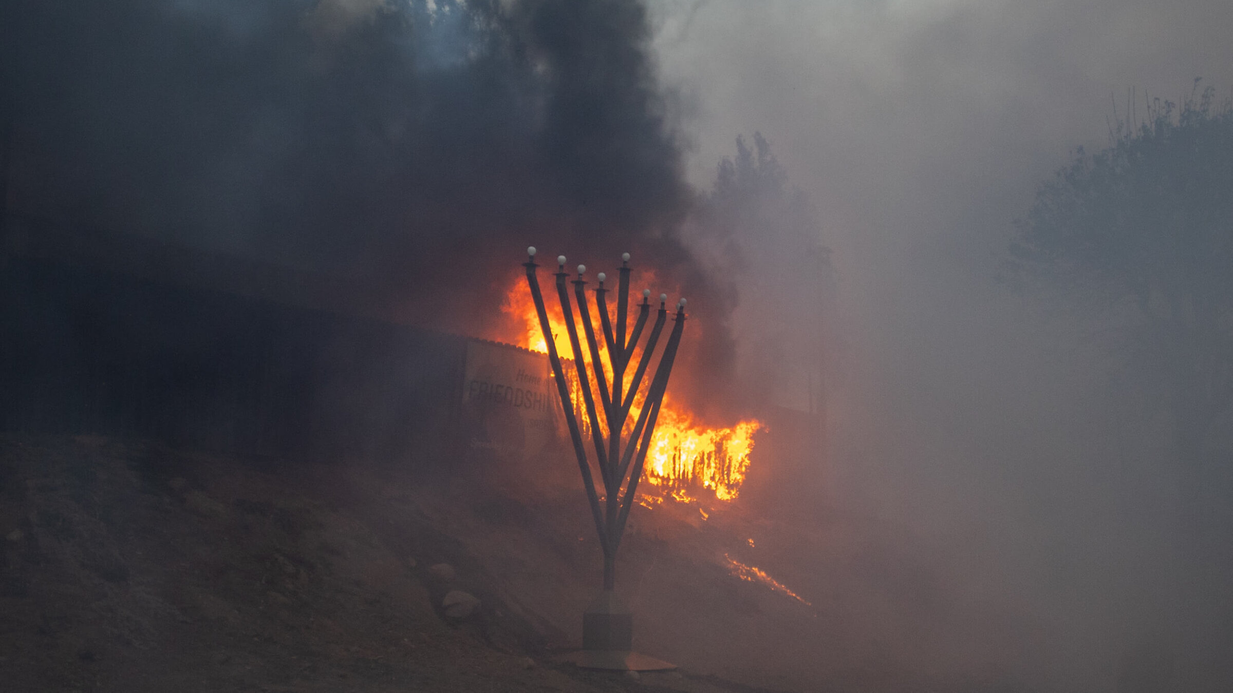 Flames from the Palisades Fire burn in front of the Jewish Temple Chabad of Pacific Palisades on Jan. 7. 