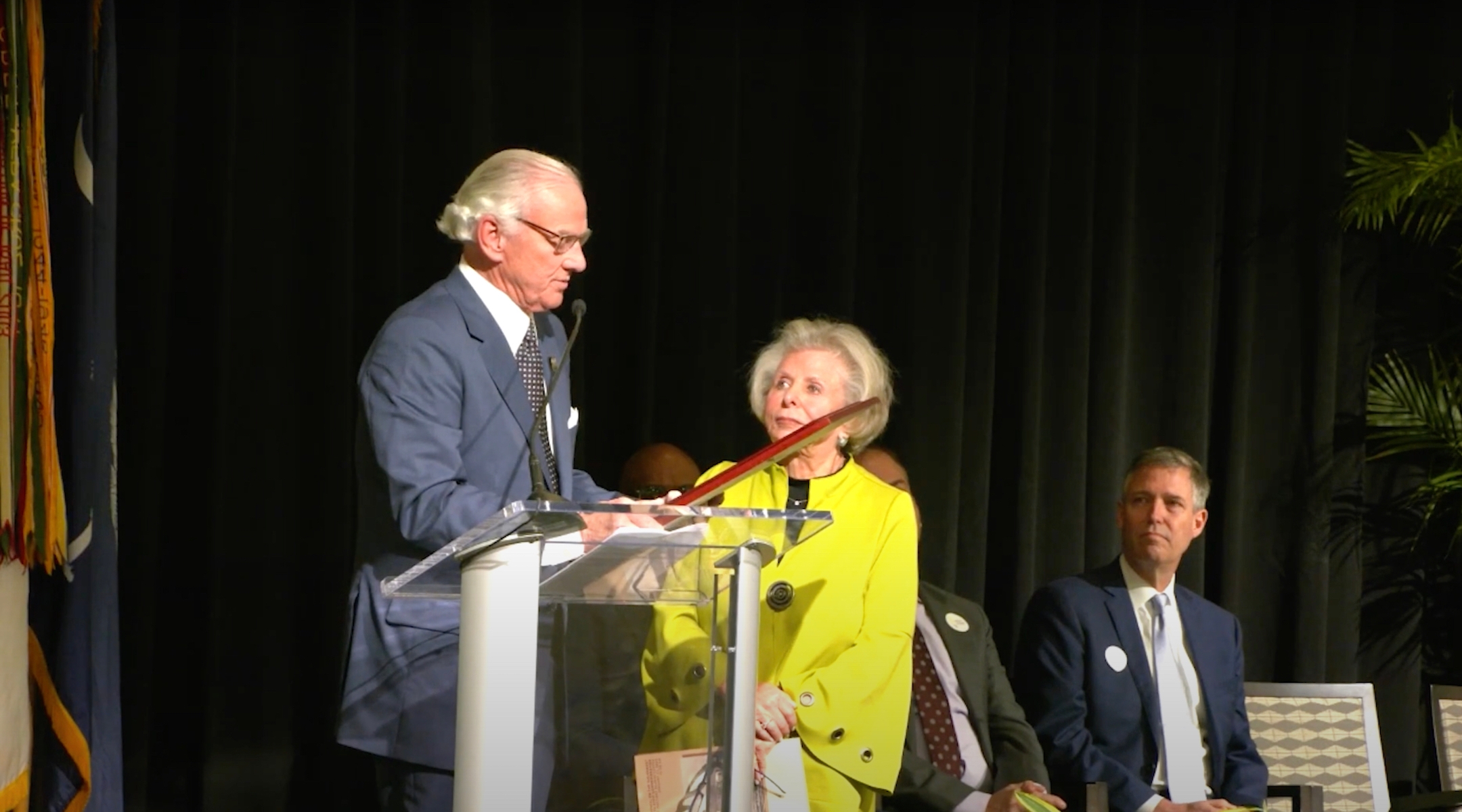 Lilly Filler (center), chair of the South Carolina Council on the Holocaust, accepts a state proclamation from Governor Henry McMaster recognizing the Holocaust during an event commemorating the 80th anniversary of the liberation of Auschwitz, Jan. 27, 2025, in Columbia, South Carolina. Filler would later cut a speech by a rabbi from the broadcast. (Screenshot via YouTube)