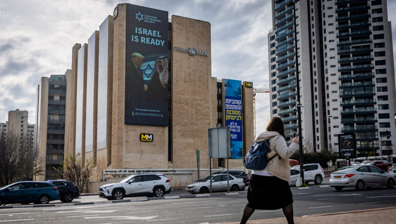 An electronic billboard shows Saudi Crown Prince Mohammed bin Salman shaking hands with U.S. President Donald Trump in Jerusalem, Feb. 3, 2025. (Chaim Goldberg/Flash90)