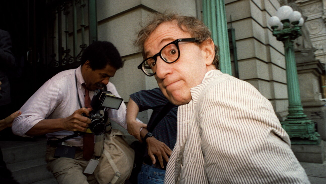 Woody Allen making his way through the media to the courthouse in New York where a judge gave Mia Farrow custody of their children.