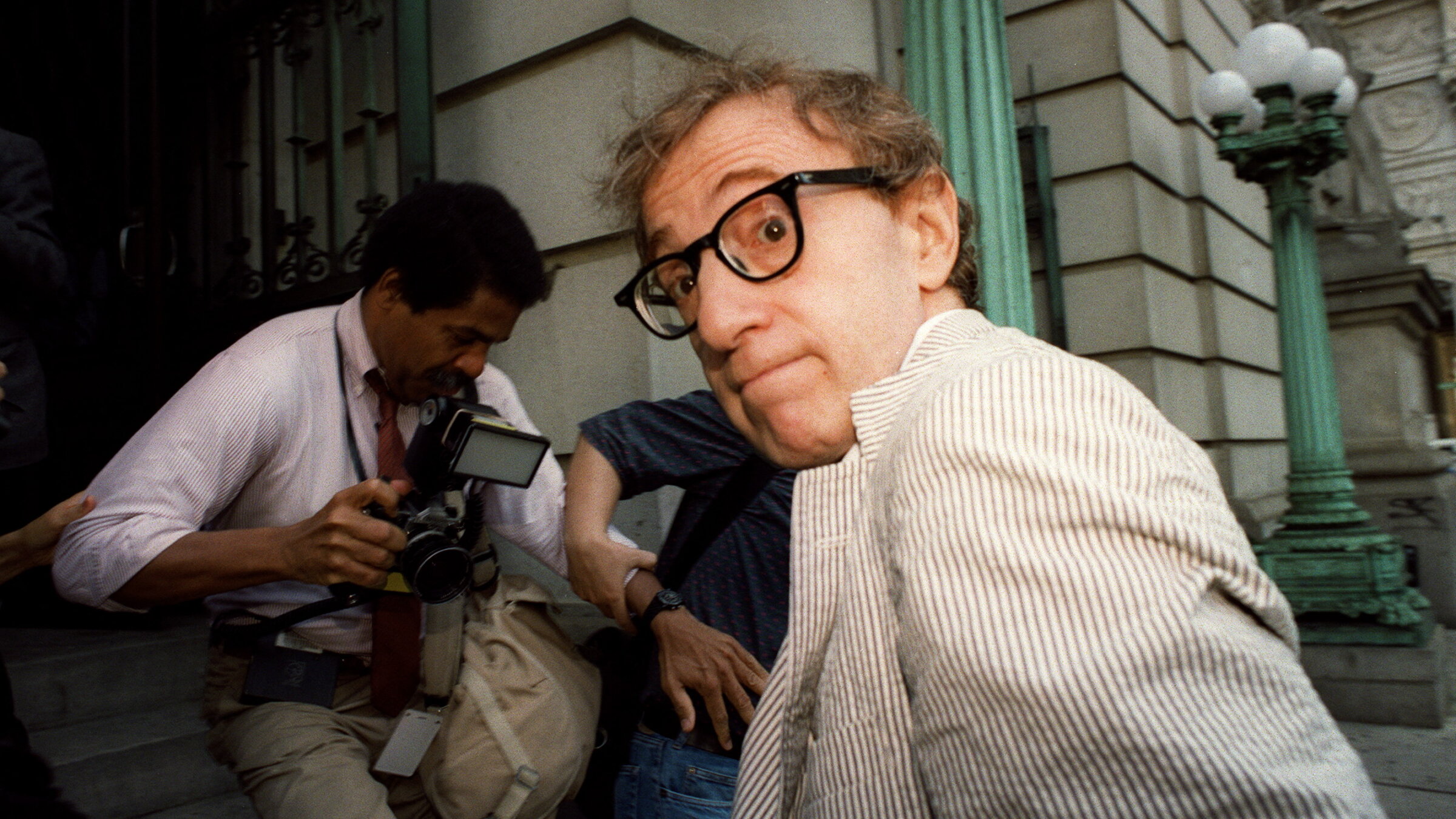 Woody Allen making his way through the media to the courthouse in New York where a judge gave Mia Farrow custody of their children.