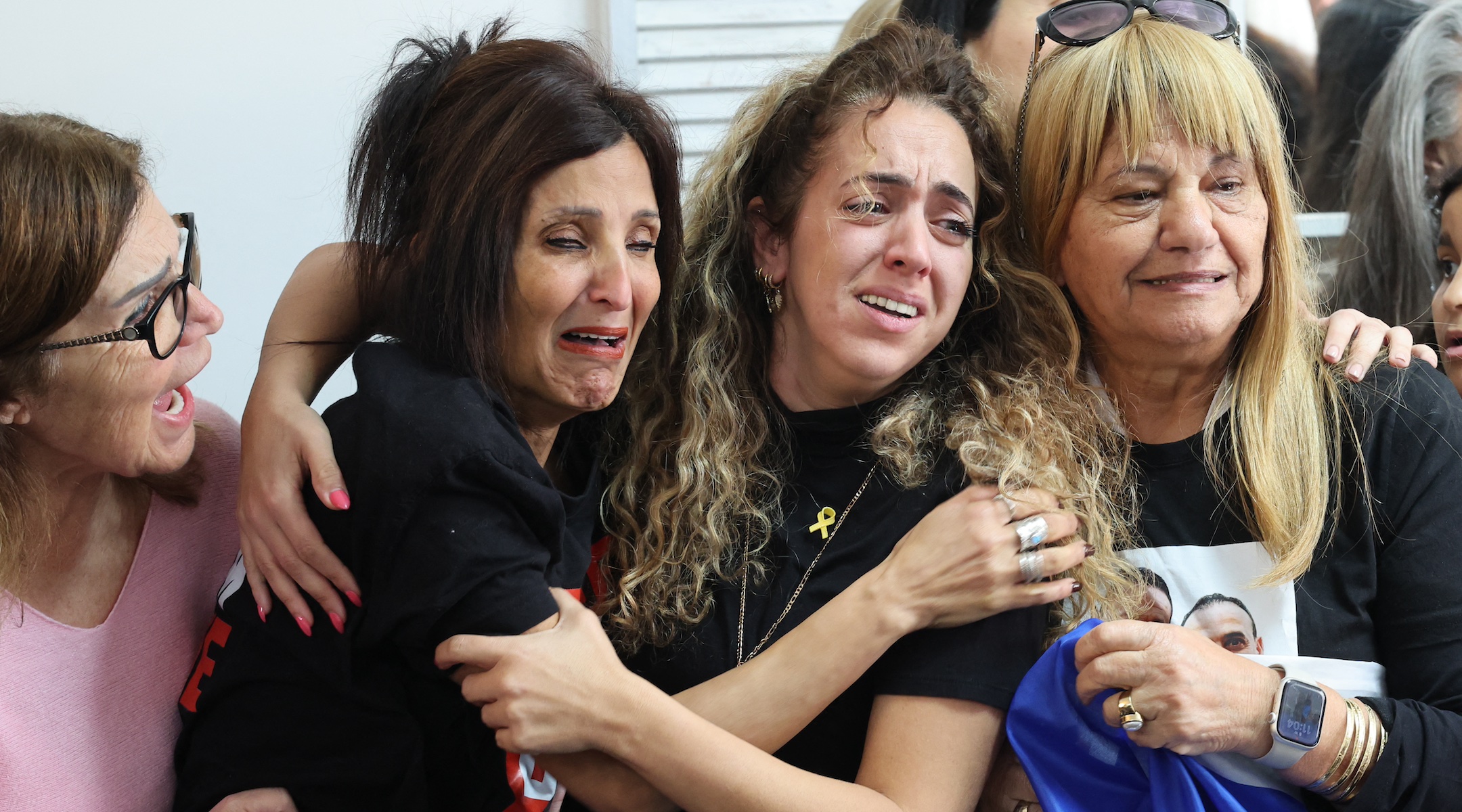 Close relatives of Israeli hostage Eli Sharabi, at the family home in Tel Aviv, react as they watch on a television screen his release along with two other hostages in the Gaza Strip, Feb. 8, 2025. (Jack Guez/AFP via Getty Images)