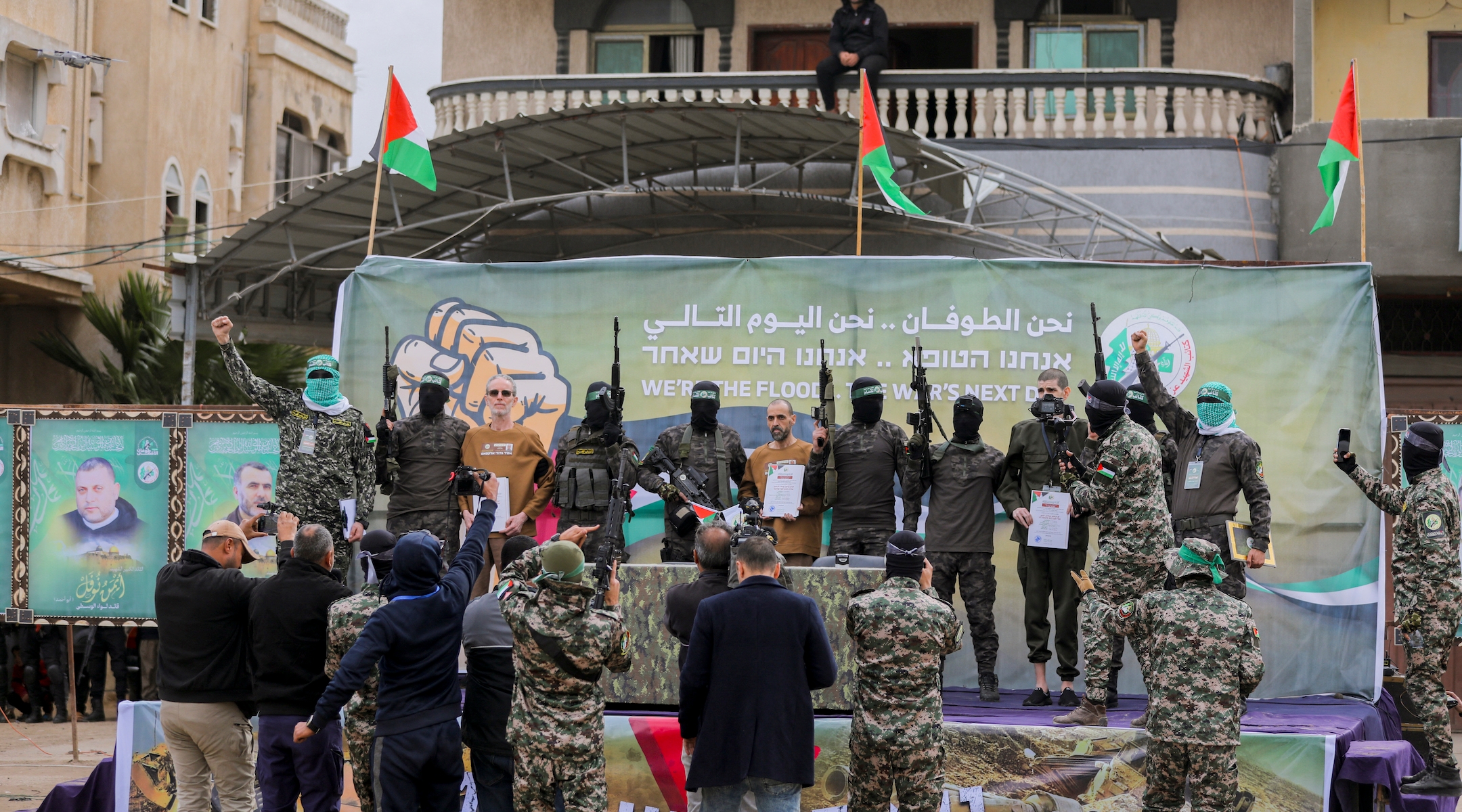 Israeli hostages stand on stage flanked by Hamas militants during the official handover in Gaza, Gaza Strip, on February 8, 2025. (Youssef Alzanoun / Middle East Images / Middle East Images via AFP)